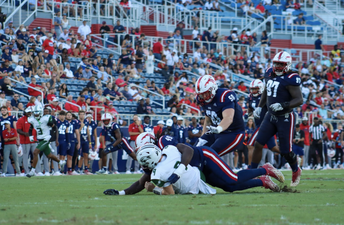 FAU defensive end Chris Jones tackling a Seahawk player.